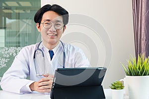 Doctor man smile using black modern smart digital tablet computer