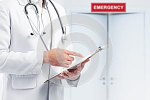 Doctor man with stethoscope holding a clipboard on the emergency room