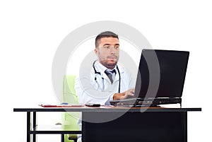 Doctor man typing on laptop in office