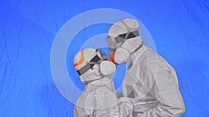 Doctor man and woman in protective costume suit, gas protect medical spray paint mask. Love couple kiss and hug, health