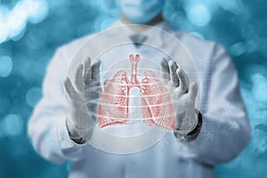 Doctor manipulates so the circulation of air flows in the lungs on a blurred background