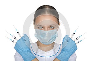 Doctor in mask and gloves holding syringe