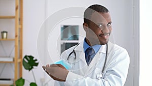 Doctor mask portrait young male takes off protective mask and poses while working at modern clinic spbas.