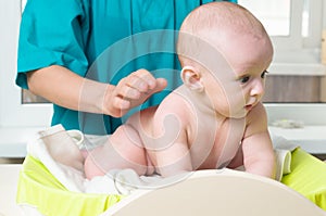 Doctor massaging baby photo