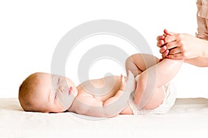 Doctor massaging or doing gymnastics baby photo