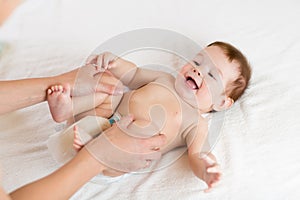 Doctor massaging infant baby