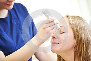 doctor measure eye pressure from female patient