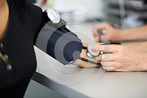 Doctor measures the blood pressure of a patient