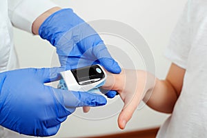 Doctor measures the oxygen saturation of child. Concept of detection of asymptomatic coronavirus