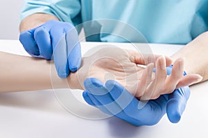 The doctor measures the pulse of the patient. Medical concept photo