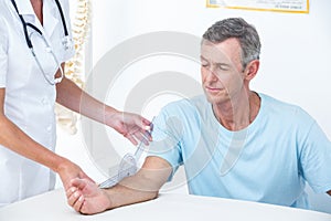 Doctor measuring arm with goniometer