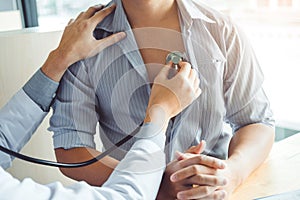 Doctor Measuring arterial blood pressure man patient Health care in hospital