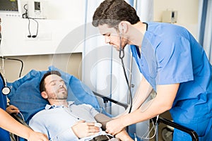 Doctor measuring blood pressure of a patient