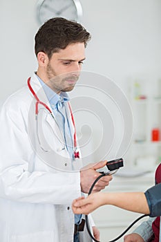 Doctor measuring blood pressure patient