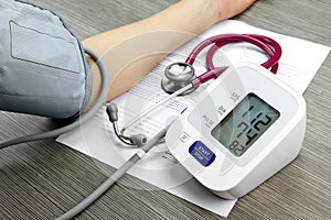 Doctor measuring blood pressure of patient.