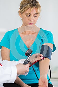 Doctor measuring blood pressure patient