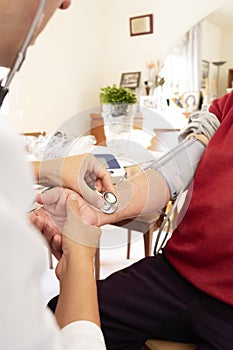 Doctor measuring the blood pressure of a senior