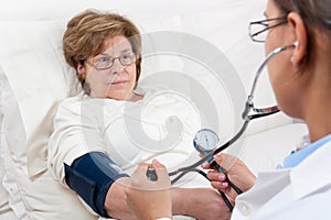 Doctor measuring Blood Pressure on Senior Patient