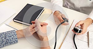 Doctor measuring blood pressure to patient in clinic 4k movie slow motion