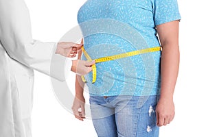 Doctor measuring fat woman`s waist