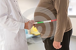 Medico misurazione obeso uomo cintura corpo grasso. obesità un peso perdita 