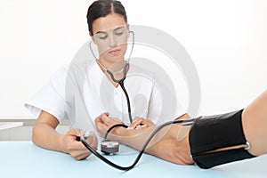 Doctor measuring patient blood pressure