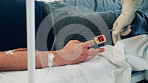 Doctor is measuring patient`s saturation with a pulse oximeter