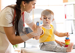 Doctor measuring temperature cute kid