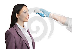 Doctor measuring woman`s temperature on white background, closeup. Prevent spreading of Covid-19