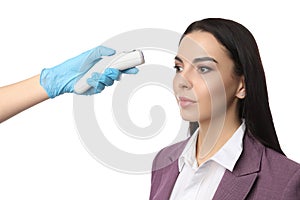 Doctor measuring woman`s temperature on white background, closeup. Prevent spreading of Covid-19