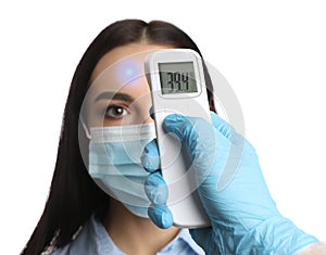 Doctor measuring woman`s temperature on white background, closeup. Prevent spreading of Covid-19