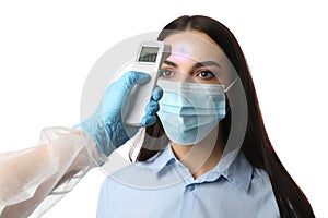 Doctor measuring woman`s temperature on white background, closeup. Prevent spreading of Covid-19