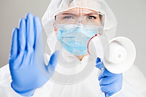 Doctor or medic in white protective suit