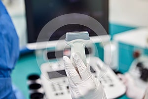 Doctor with medical equipment for ultrasound examination of leg veins. Phlebologist working in modern clinic with Varicose Veins