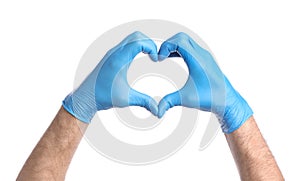 Doctor in medical gloves making heart with hands on white background, closeup