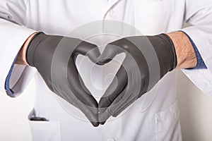 Doctor in medical gloves, show heart symbol with hand in soap foam isolated on white background. Hands hygiene