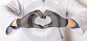 Doctor in medical gloves, show heart symbol with hand in soap foam isolated on white background. Hands hygiene