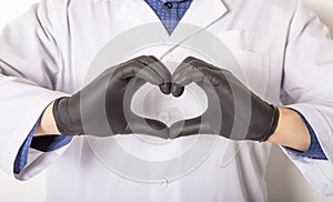 Doctor in medical gloves, show heart symbol with hand in soap foam isolated on white background. Hands hygiene