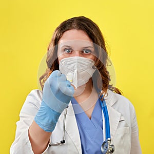 A doctor in medical gloves shows a fist, close-up. The concept of self-isolation in the case of a coronavirus pandemic and removal