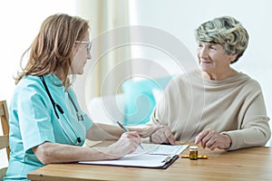Doctor on medical home appointment photo