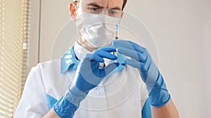 Doctor in medical mask and blue gloves preparing to injection.
