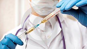 Doctor in medical mask and blue gloves preparing to injection.