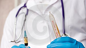 Doctor in medical mask and blue gloves preparing to injection.