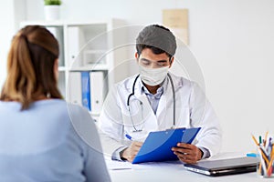 Doctor in medical mask and patient at hospital