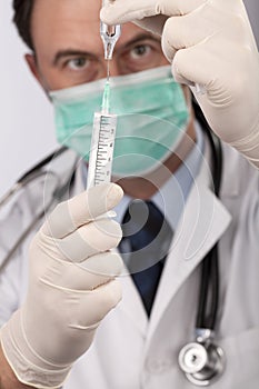 Doctor with medical syringe in hands