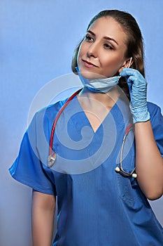 Doctor in medical uniform, protective mask and gloves, with stethoscope isolated. Coronavirus Epidemic COVID-19
