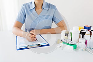 Doctor with medicines and clipboard at hospital