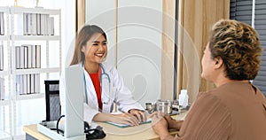 Doctor meeting and explaining medication to old woman patient at Hospitals