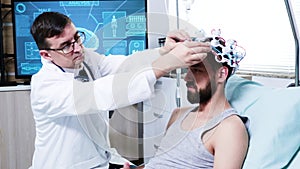 Doctor in a neuroscience centre preparing patien for brain analysis