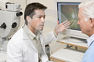 Doctor Next To Equipment To Detect Glaucoma photo